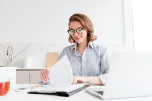 Photo of cheerful attractive woman in glasses reading new contra