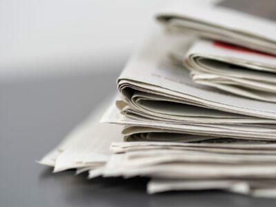 A closeup shot of several newspapers stacked on top of each other