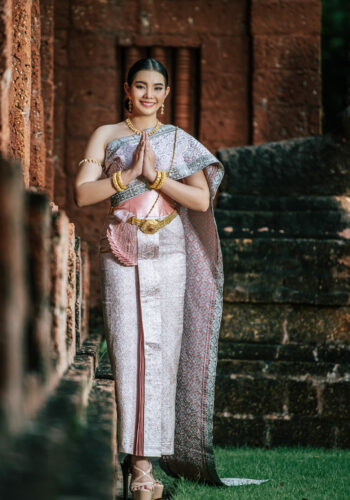 Asian charming woman wearing typical Thai dress identity culture Portrait Asian charming woman wearing beautiful typical Thai dress identity culture of Thailand in ancient temple or famous place with gracefully pose, copy space