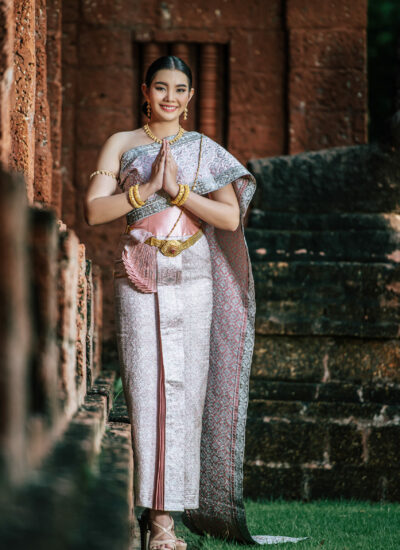 Portrait Asian charming woman wearing beautiful typical Thai dress identity culture of Thailand in ancient temple or famous place with gracefully pose, copy space