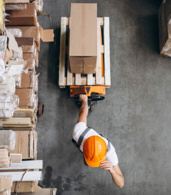 Young man working at a warehouse with boxes