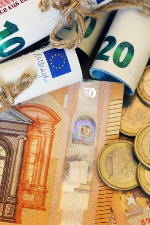 High angle shot of some rolled banknotes and coins on more banknotes A high angle shot of some rolled banknotes and coins on more banknotes