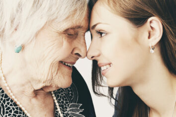 Beautiful girl and her grandmother Elderly woman with her granddaughter
