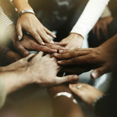 Closeup of diverse people joining their hands Closeup of diverse people joining their hands